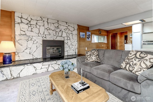 living room featuring light carpet and wooden walls