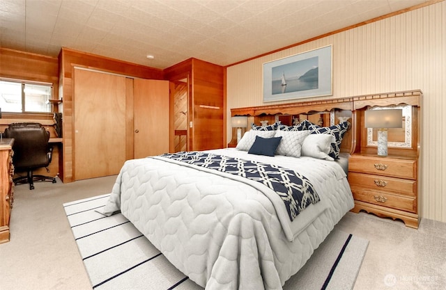 bedroom featuring a closet and light colored carpet