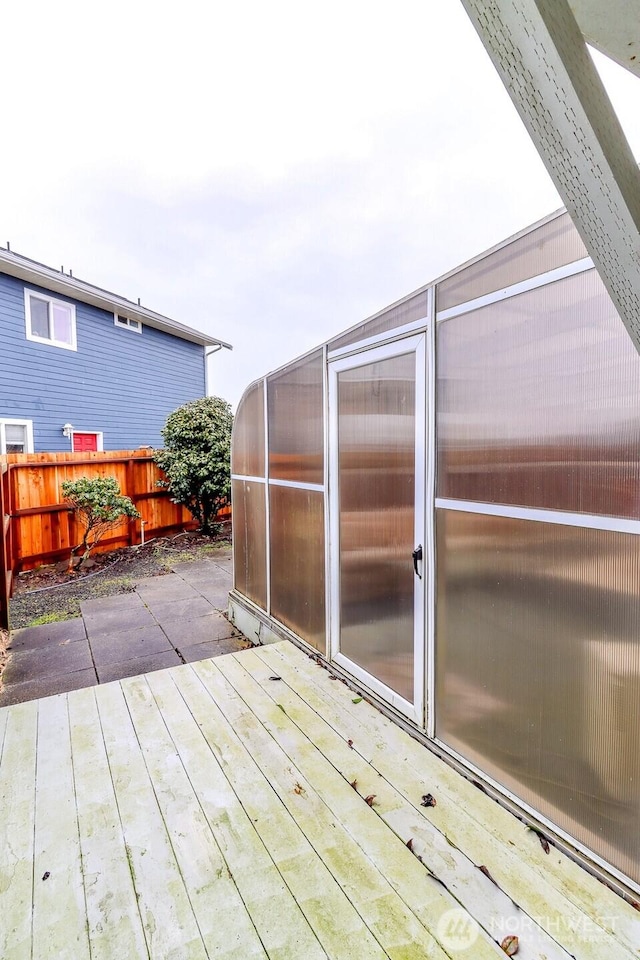 wooden deck featuring fence and an outbuilding