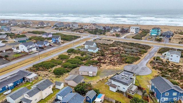 drone / aerial view with a residential view and a water view