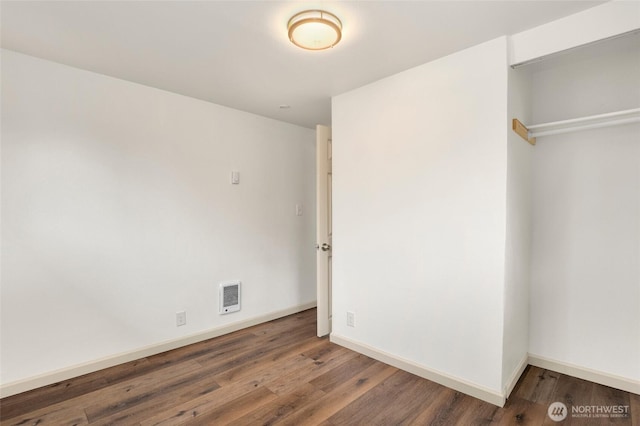 unfurnished bedroom with visible vents, baseboards, and wood finished floors