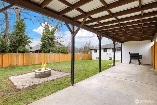 view of patio / terrace with a fenced backyard and a fire pit