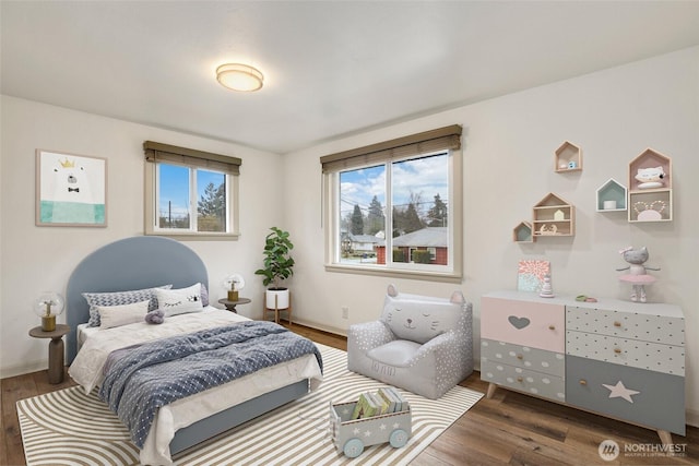 bedroom with baseboards and wood finished floors