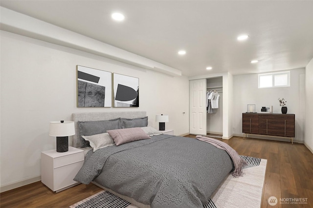 bedroom with a closet, baseboards, wood finished floors, and recessed lighting