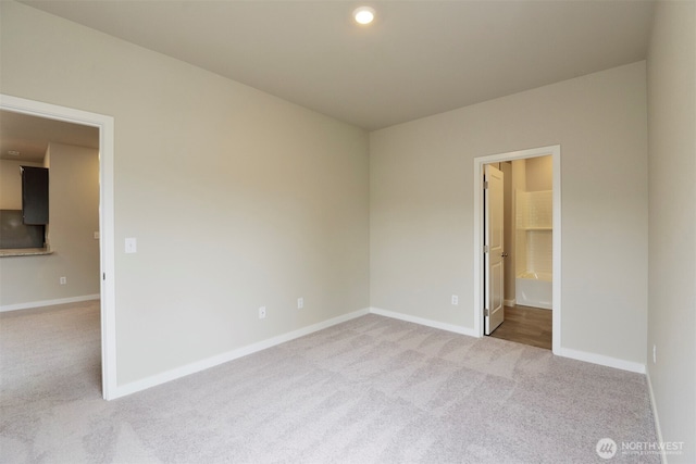 unfurnished room with light carpet, baseboards, and recessed lighting