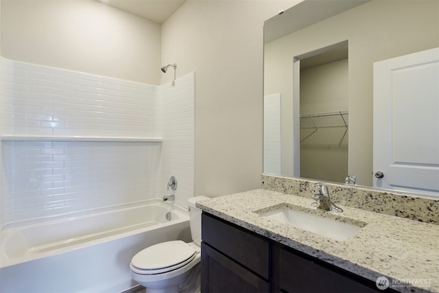 full bathroom featuring toilet, a spacious closet, vanity, and shower / bathtub combination