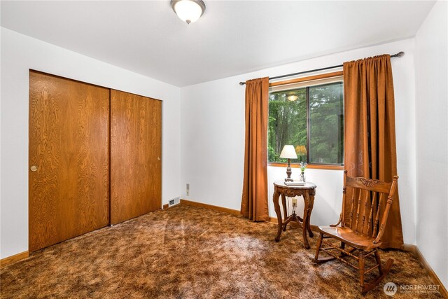 sitting room with baseboards, visible vents, and dark carpet