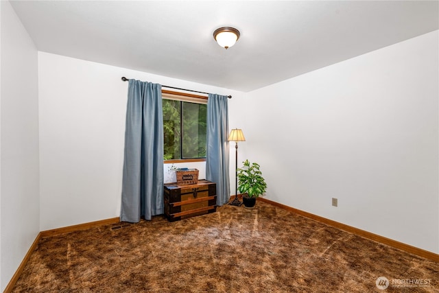 spare room with carpet, visible vents, and baseboards