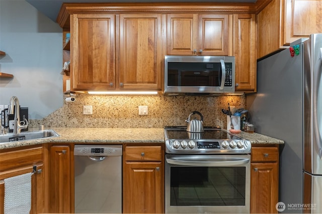 kitchen with a sink, appliances with stainless steel finishes, open shelves, tasteful backsplash, and brown cabinetry