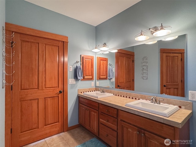 full bathroom with tile patterned flooring, a sink, and double vanity