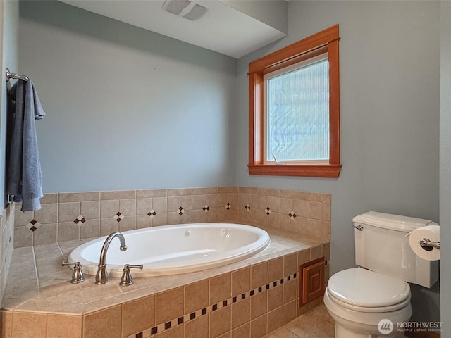 full bath featuring a bath, toilet, and tile patterned floors