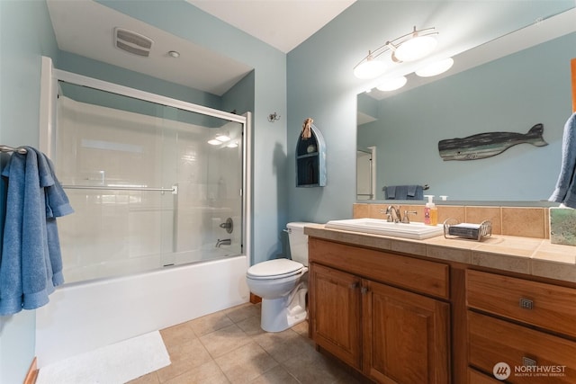 full bath with visible vents, toilet, shower / bath combination with glass door, tile patterned flooring, and vanity