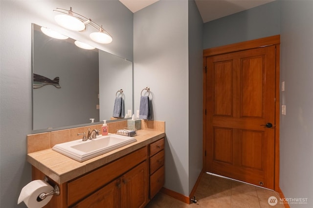 bathroom with tile patterned flooring, vanity, and baseboards