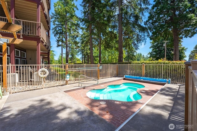 view of swimming pool with a patio area, fence, and a fenced in pool