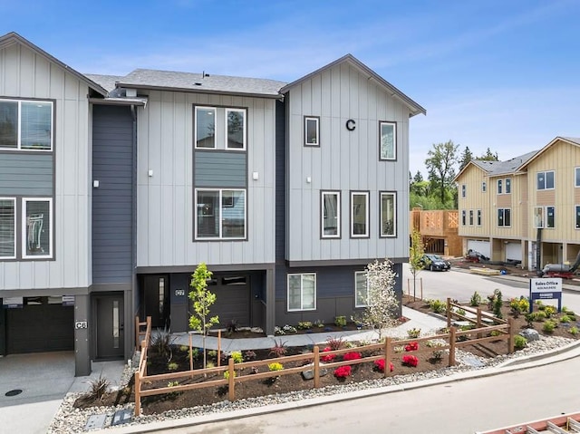 view of front of property featuring board and batten siding, driveway, and an attached garage