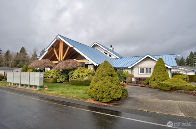 view of front facade with metal roof and a standing seam roof