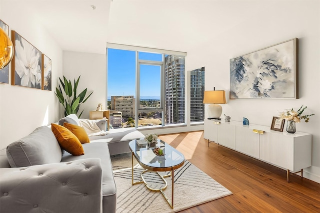 living room with a view of city and wood finished floors