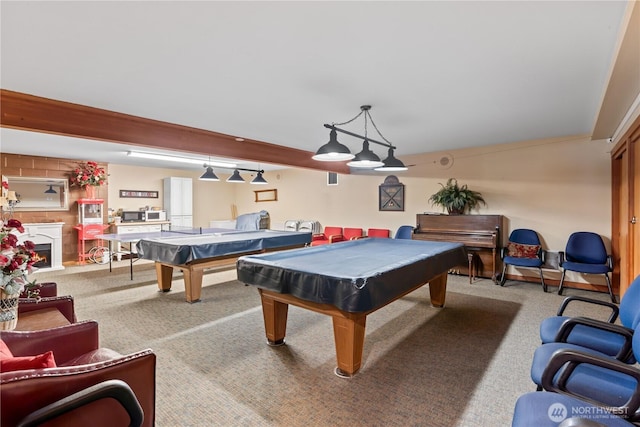 rec room featuring pool table, a warm lit fireplace, and light carpet