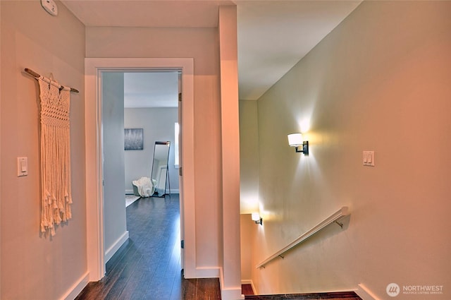 corridor with baseboards and dark wood finished floors