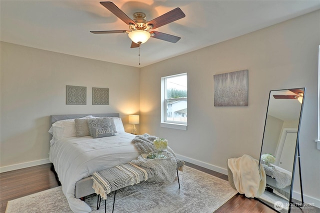 bedroom featuring dark wood finished floors, a ceiling fan, and baseboards