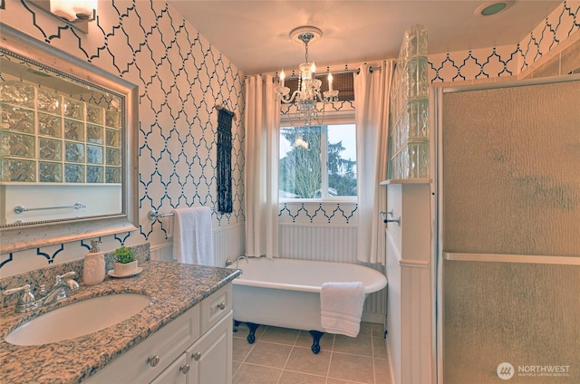 full bath with a stall shower, tile patterned floors, a freestanding bath, vanity, and a chandelier