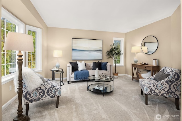 living room featuring carpet floors, baseboards, and vaulted ceiling