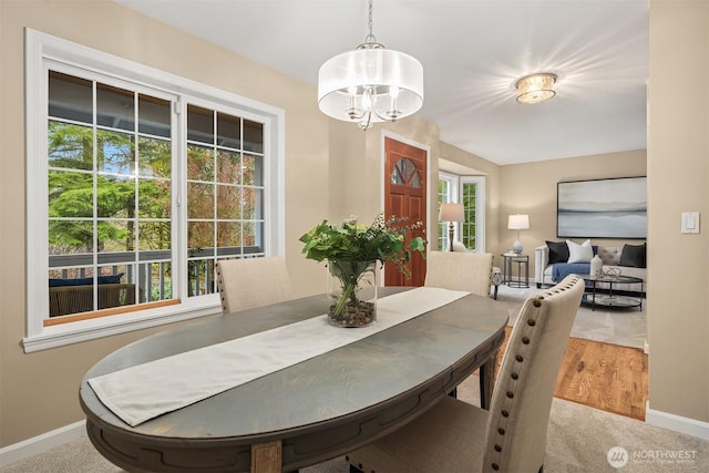 dining room featuring baseboards and a notable chandelier