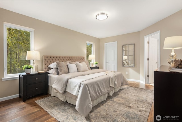 bedroom featuring dark wood-type flooring and baseboards