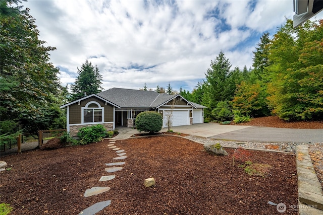 ranch-style house featuring driveway, stone siding, and a garage