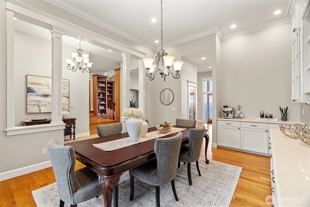 dining area featuring ornate columns, light wood-style floors, and a notable chandelier