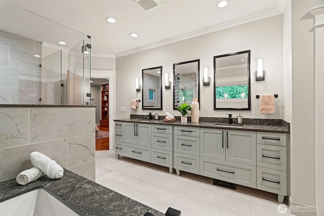 full bathroom featuring double vanity, crown molding, visible vents, and a sink