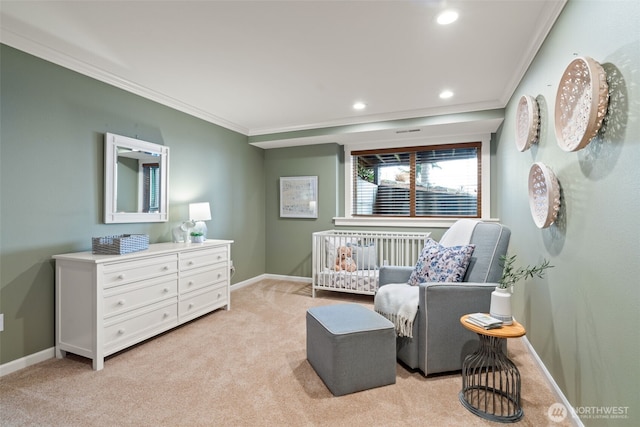 sitting room with light carpet, baseboards, and ornamental molding