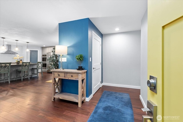 entrance foyer featuring dark wood-type flooring, recessed lighting, and baseboards