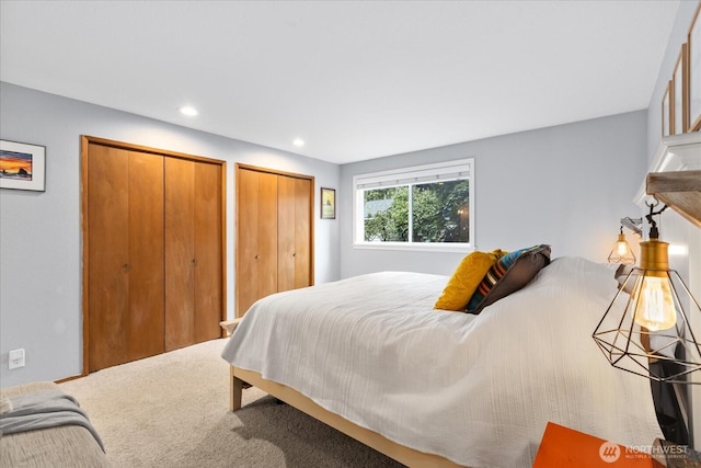 bedroom with recessed lighting and multiple closets