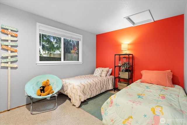 carpeted bedroom with attic access and baseboards