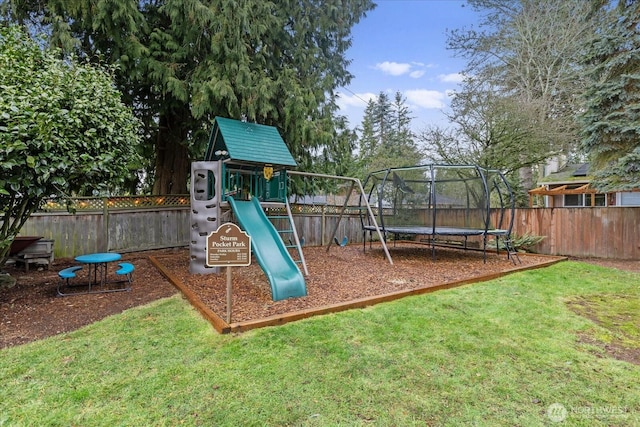 view of jungle gym featuring a yard, a trampoline, and a fenced backyard