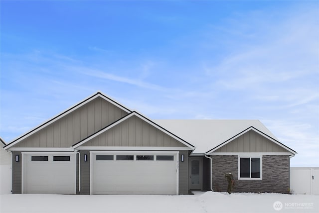 view of front facade featuring a garage and stone siding