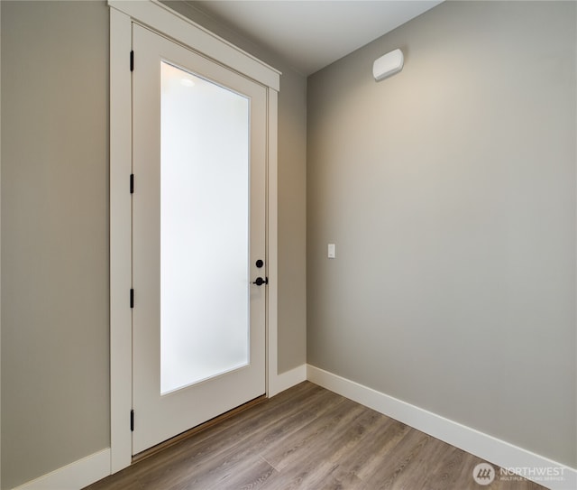 entryway featuring light wood-style flooring and baseboards