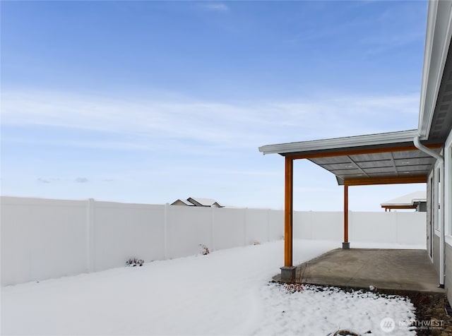 yard covered in snow featuring a fenced backyard