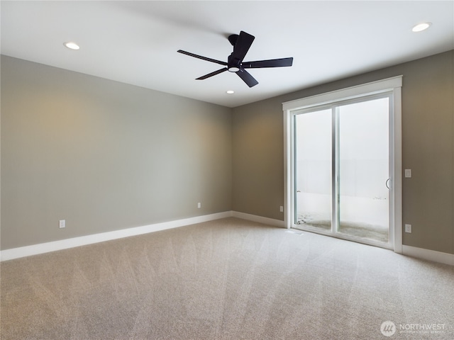 spare room featuring a ceiling fan, recessed lighting, light carpet, and baseboards