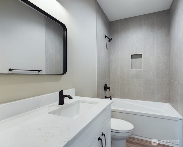 bathroom featuring  shower combination, vanity, toilet, and wood finished floors