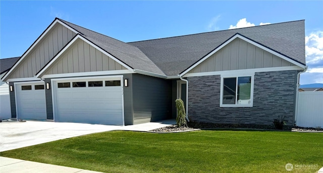 922 NE Tyler Pl E, Wenatchee, WA 98802 - view of front of house with a garage, concrete driveway, roof with shingles, and board and batten siding