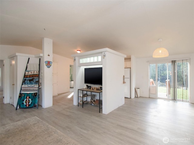 living room with light wood-type flooring and lofted ceiling