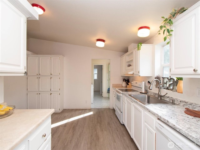 kitchen featuring light countertops, white appliances, white cabinets, and a sink