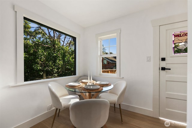 dining area featuring baseboards and wood finished floors