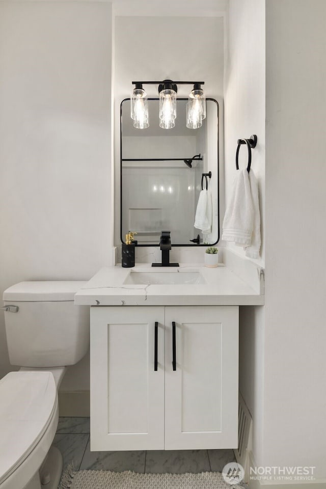 bathroom with vanity and toilet