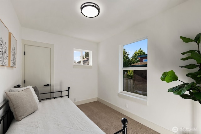 bedroom featuring carpet flooring and baseboards