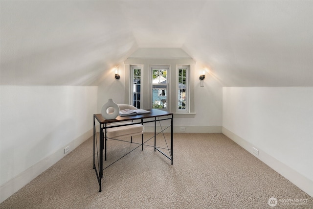 home office featuring light colored carpet, vaulted ceiling, and baseboards