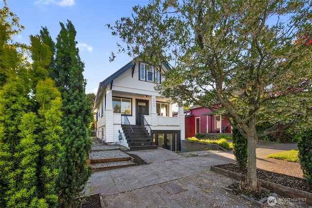 view of front of home featuring stairs and a porch