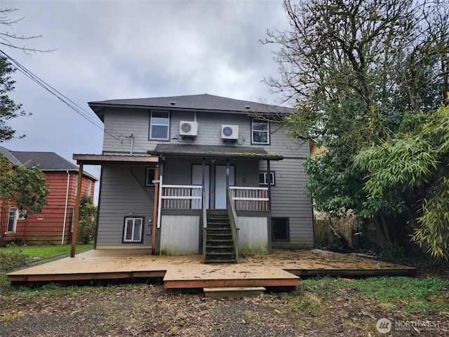 rear view of property featuring stairs and a deck